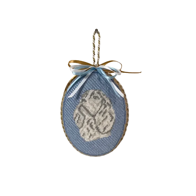 Decorative blue oval ornament with a gold bow on a white background