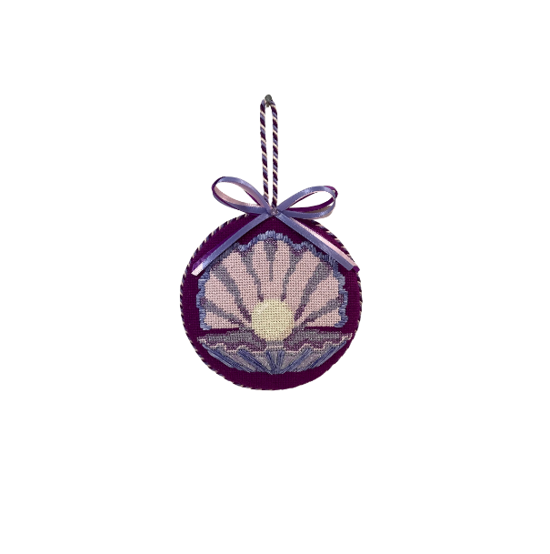 Decorative ornament with shell design and purple ribbon on a white background.
